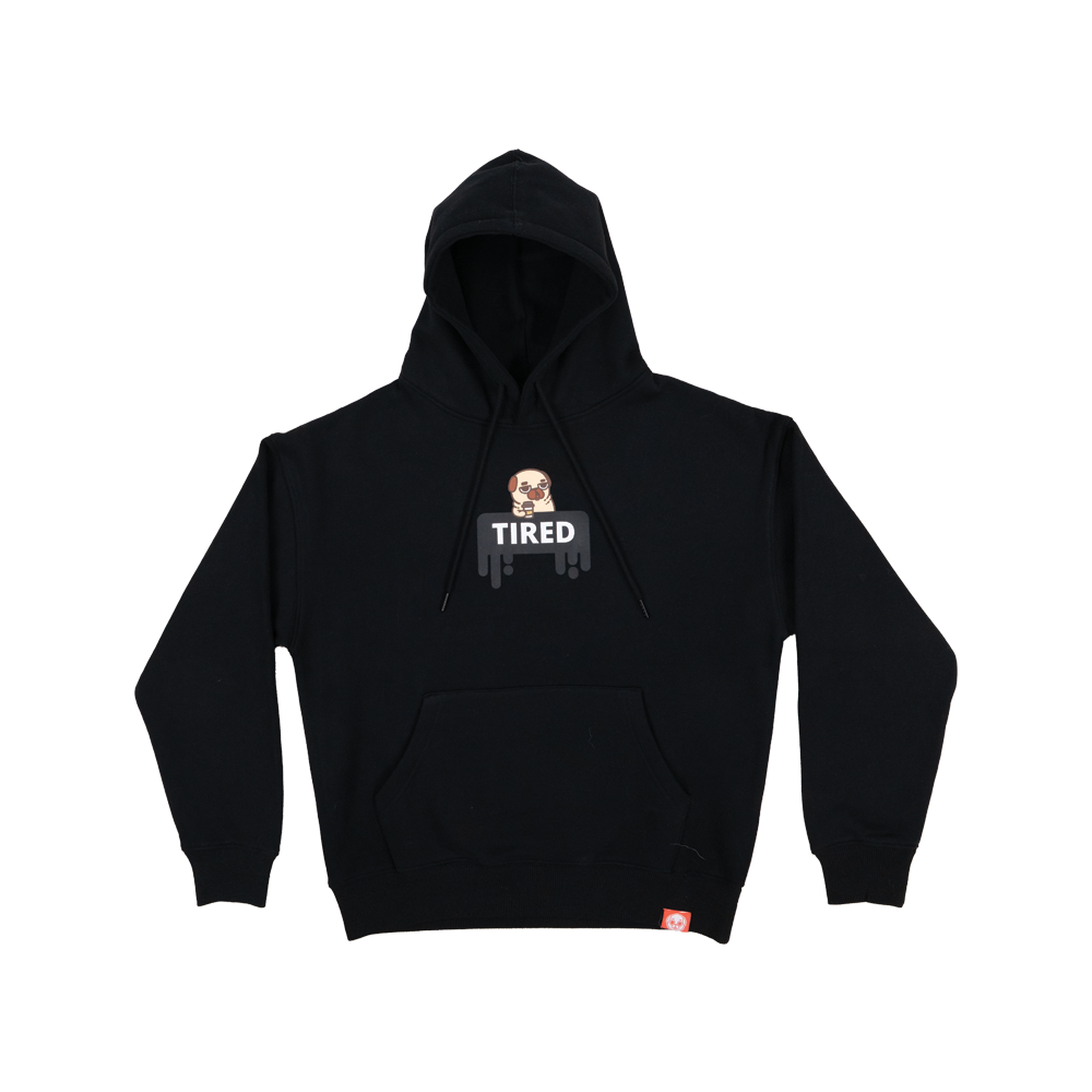 A black long-sleeved hoodie with a graphic of a tired-looking pug holding a to-go coffee cup above a black dripping rectangle with the white text "TIRED". The graphic is in the centre of the chest of the t-shirt. There is a small red tag on the bottom hem of the hoodie.