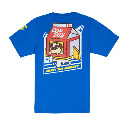 The back of a blue t-shirt with a graphic of a red, white, and yellow rocket ship shaped like a milk carton with a tan-colored pug peeking out of window. The rocket appears to be blasting milk out the bottom, and the graphic is surrounded by a geometric white diagonal rectangle with cut-out lines and sparkle emoji. The graphic is in the centre of the back of the t-shirt. A small yellow sparkle design is visible on the shoulder.